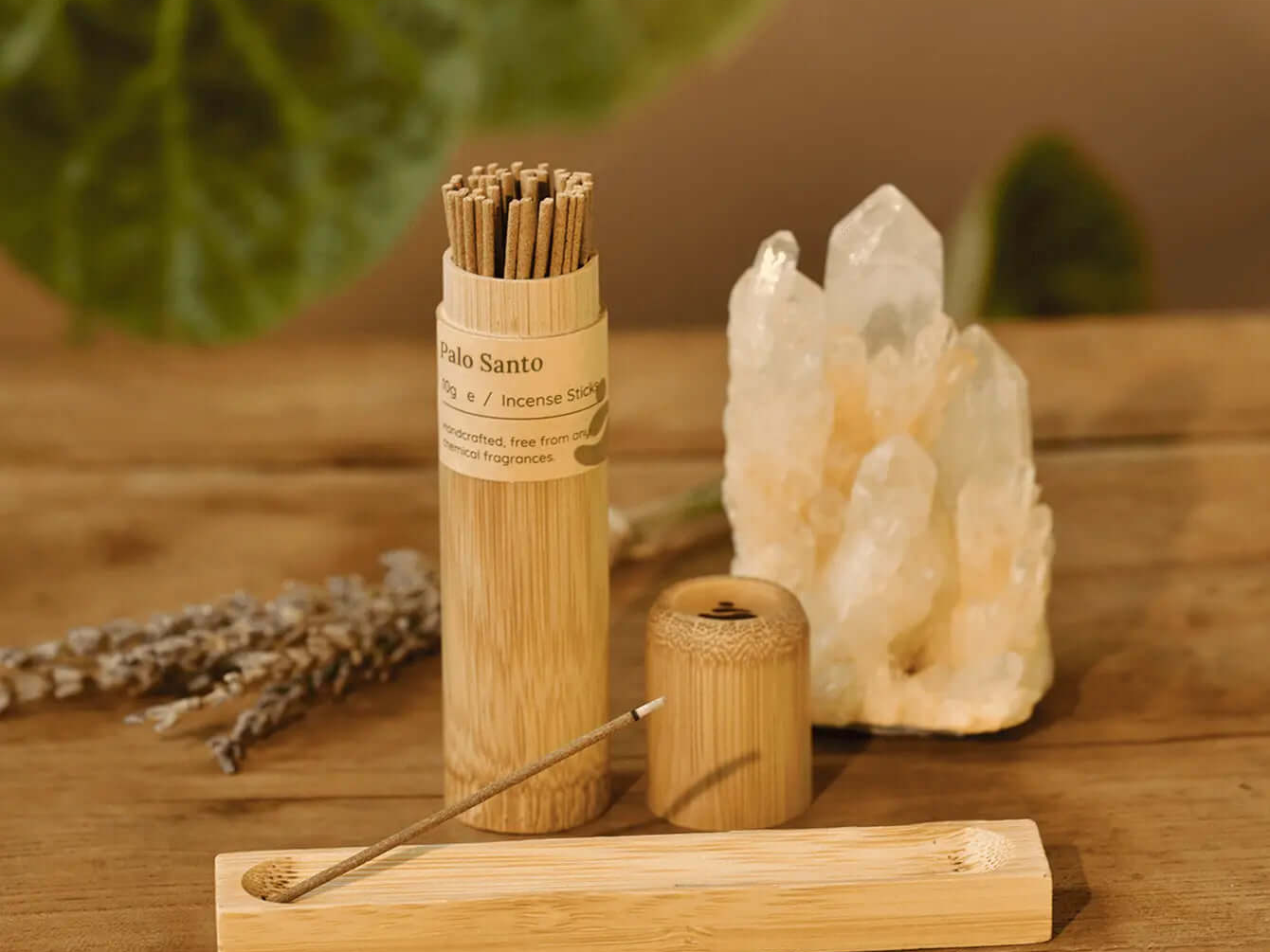 Palo Santo vs White Sage: Palo Santo incense sticks and holder on a wooden table.