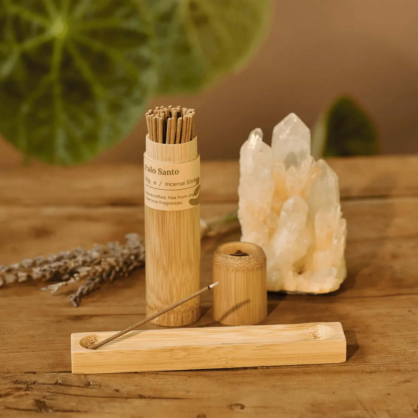 Palo Santo vs White Sage: Palo Santo incense sticks and holder on a wooden table.