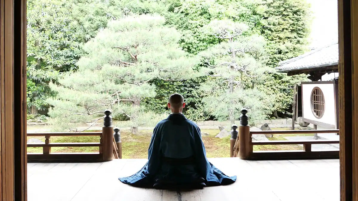 Person meditating in a serene Japanese garden, embodying the essence of 6 Japanese Mental Models That Rewire Your Brain for Calm and Clarity.