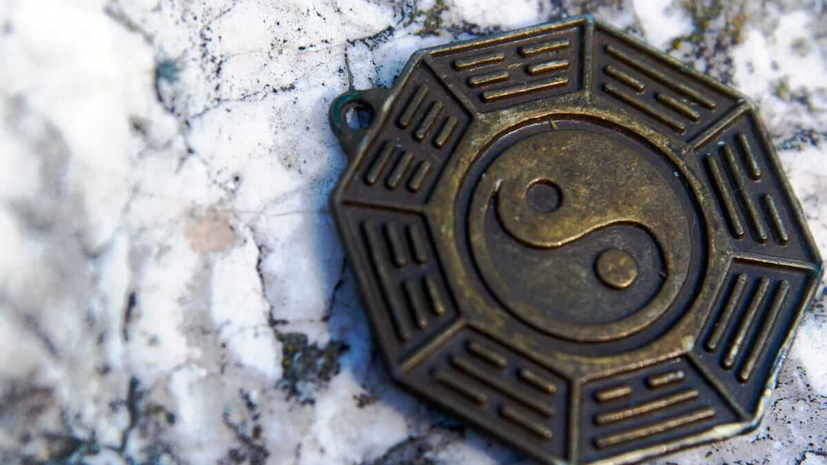 Eager to Be More Charismatic? Taoist symbol representing balance and attraction on a stone surface.