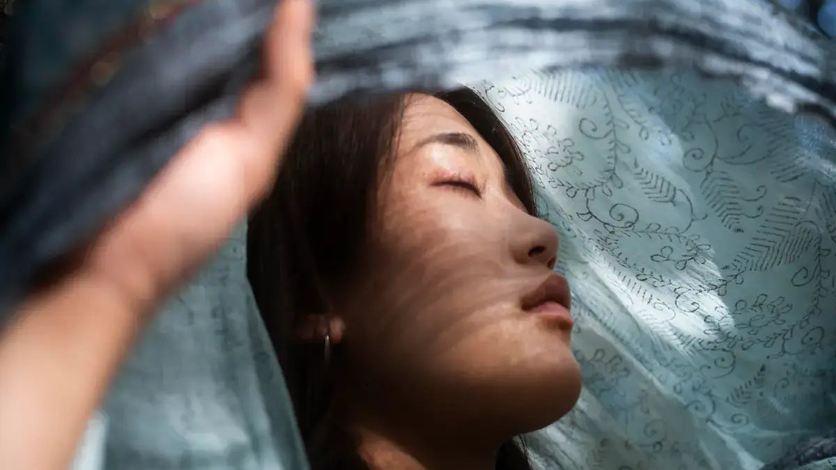 A woman gently connecting with inner peace, representing the theme of How to Let Go of Attachment.