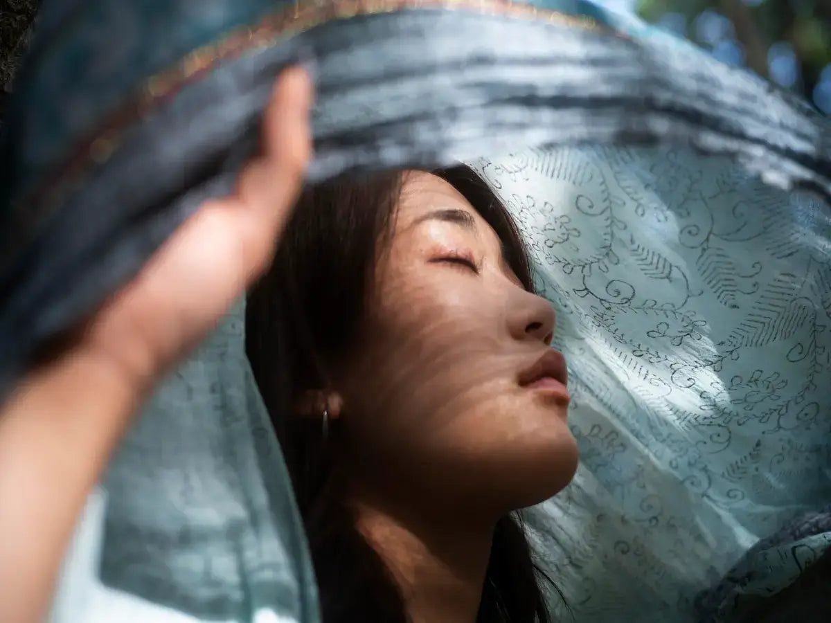 A woman gently connecting with inner peace, representing the theme of How to Let Go of Attachment.
