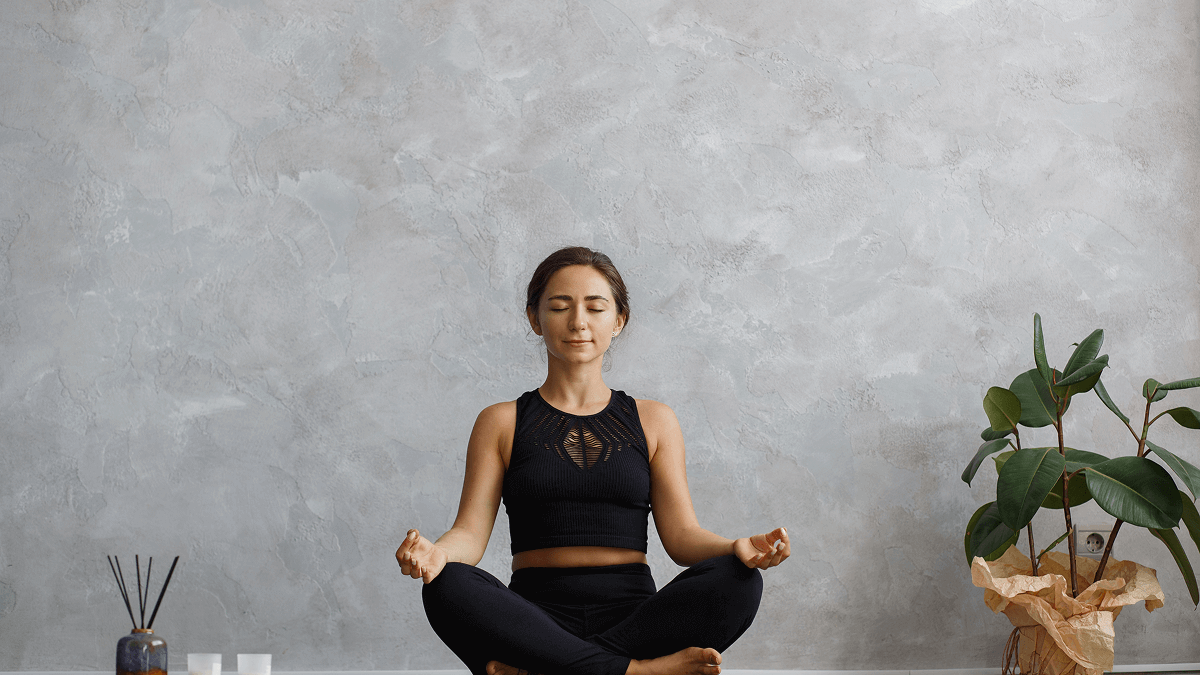How a 5-Minute Daily Sit Can Reset Your Mind & Life with a woman meditating in a serene space.