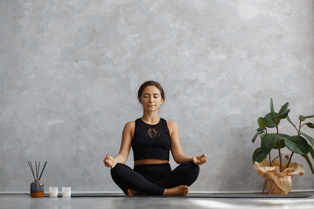 How a 5-Minute Daily Sit Can Reset Your Mind & Life with a woman meditating in a serene space.