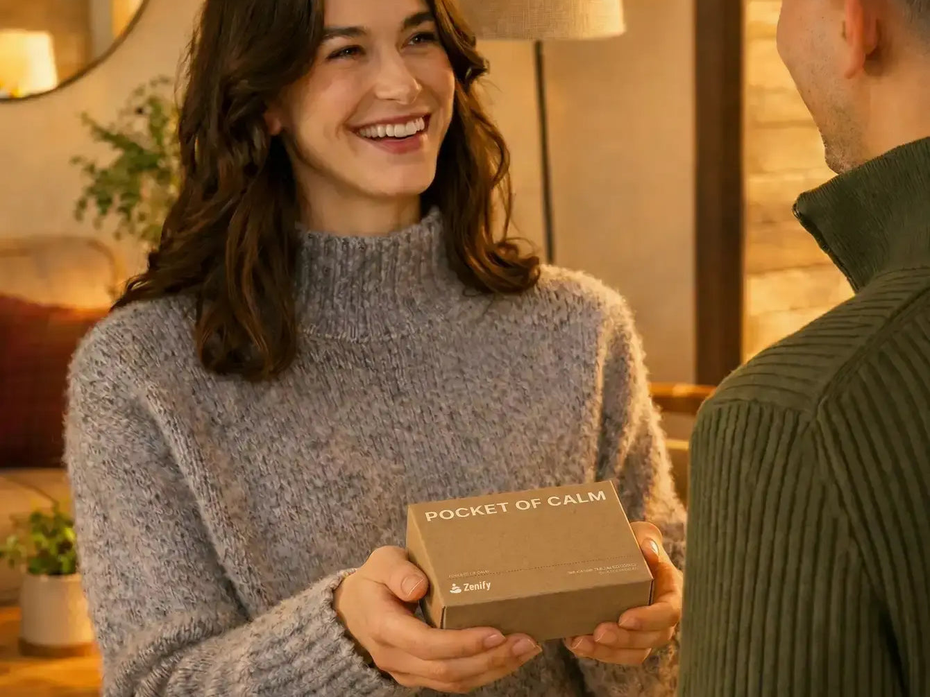 A woman giving a Pocket of Calm mini Zen garden gift box to a friend