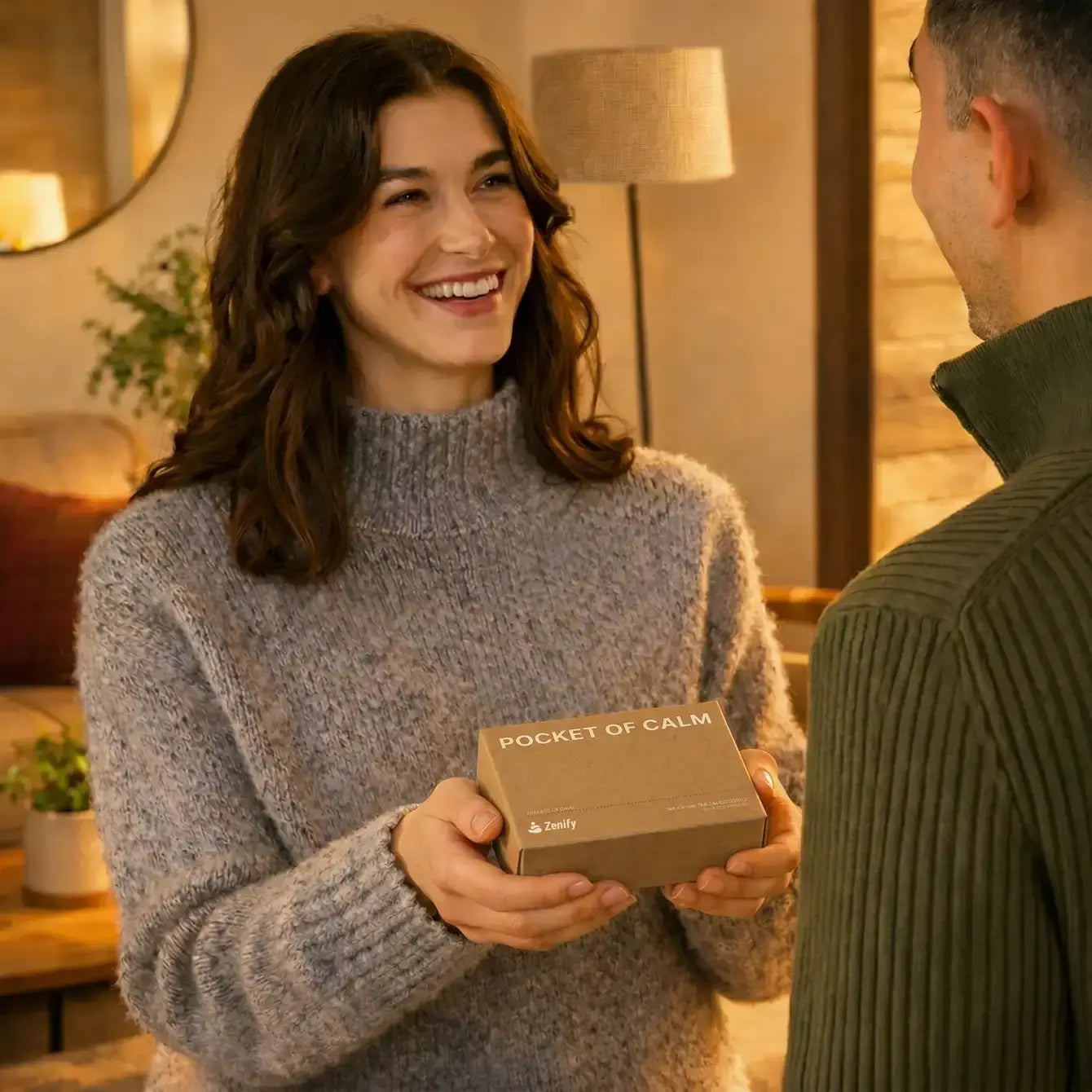 A woman giving a Pocket of Calm mini Zen garden gift box to a friend