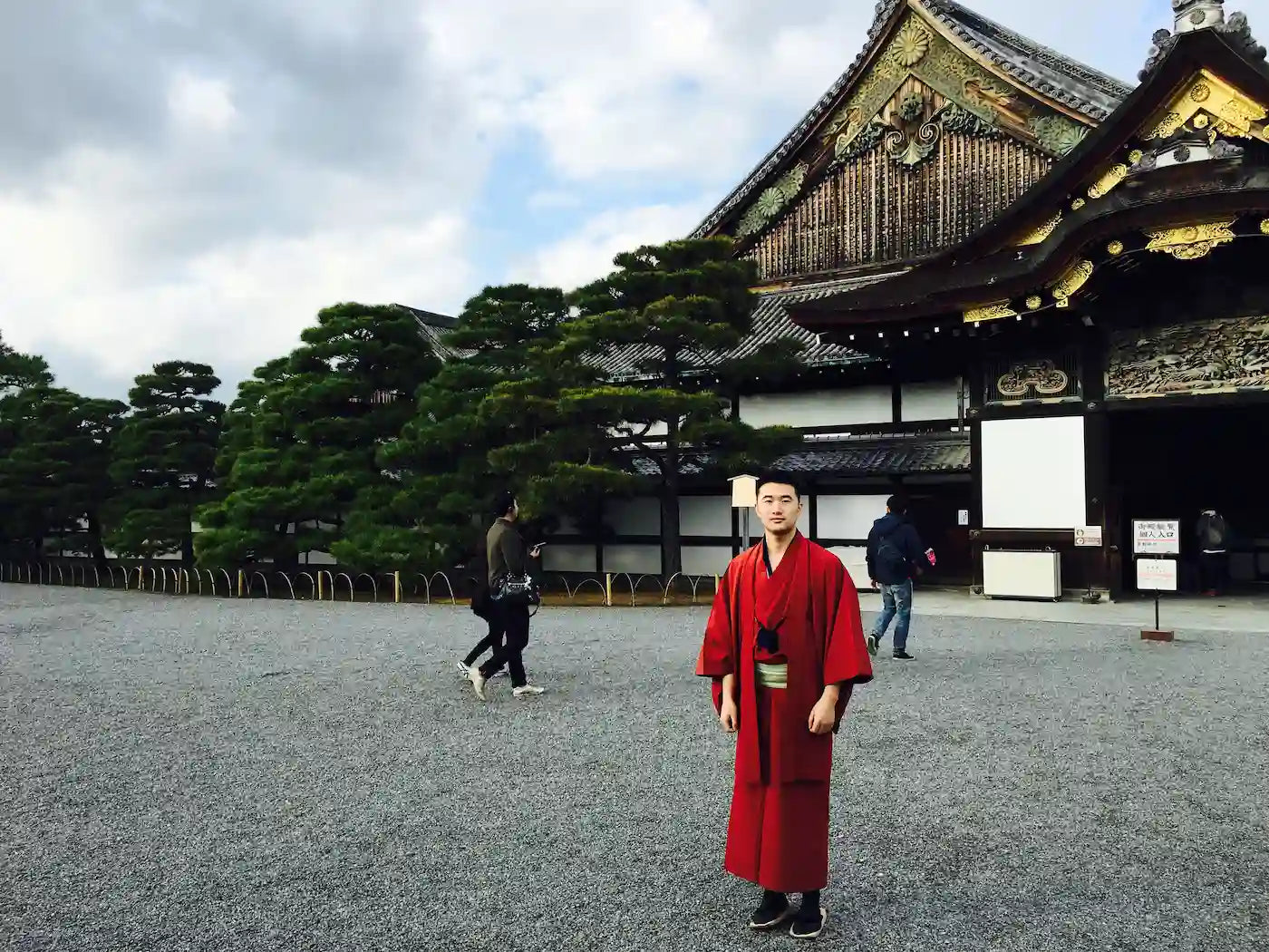 Sean, founder of Zenify, visiting Kyoto Japan wearing a traditional red kimono — the trip that inspired the crystal zen garden