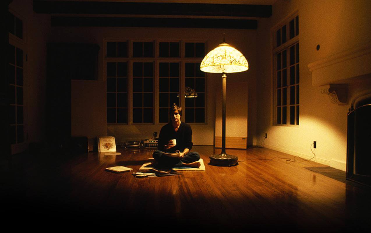 Meditating in a dimly lit room, illustrating the theme: Something Shocking Happens When You Meditate For Long Enough