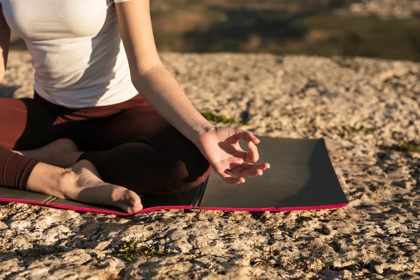 A person practicing mindfulness meditation outdoors as part of a Digital Detox Guide.