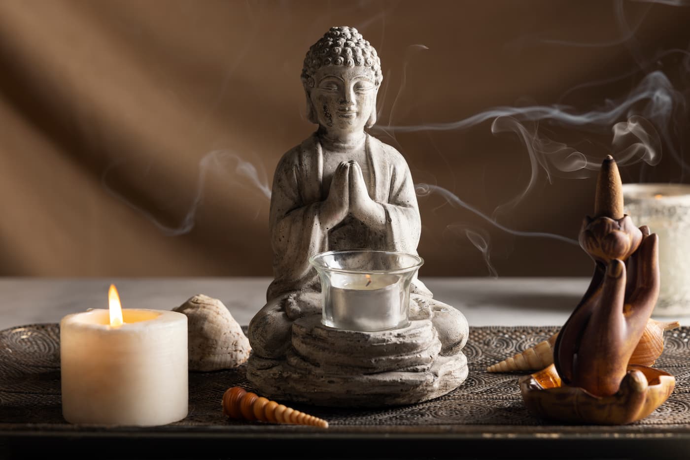 Buddhism on What Blocks Your Happiness, featuring a meditating Buddha statue and candles.