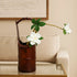Handcrafted bamboo flower vase with white flowers, adding a serene touch to contemporary decor.