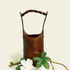 Handcrafted Zen bamboo flower vase with elegant design and green leaves, perfect for serene decor.