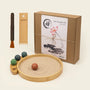Desktop Zen Garden kit featuring bamboo sand tray, rake, brush, and decorative stones for desk relaxation.