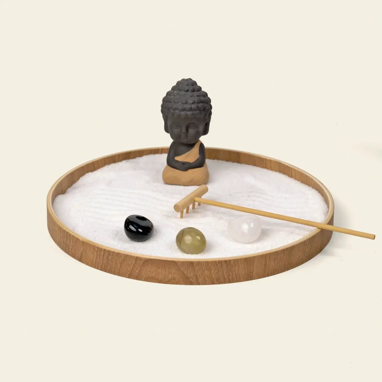 Zen Garden featuring a meditative statue, sand, and decorative stones for tranquility and mindfulness.