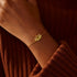 Double-layer lotus bracelet in gold on a hand, showcasing elegance with S925 Sterling Silver Zircon Bracelet.