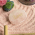 Pink lotus-inspired accent and moss-textured stones