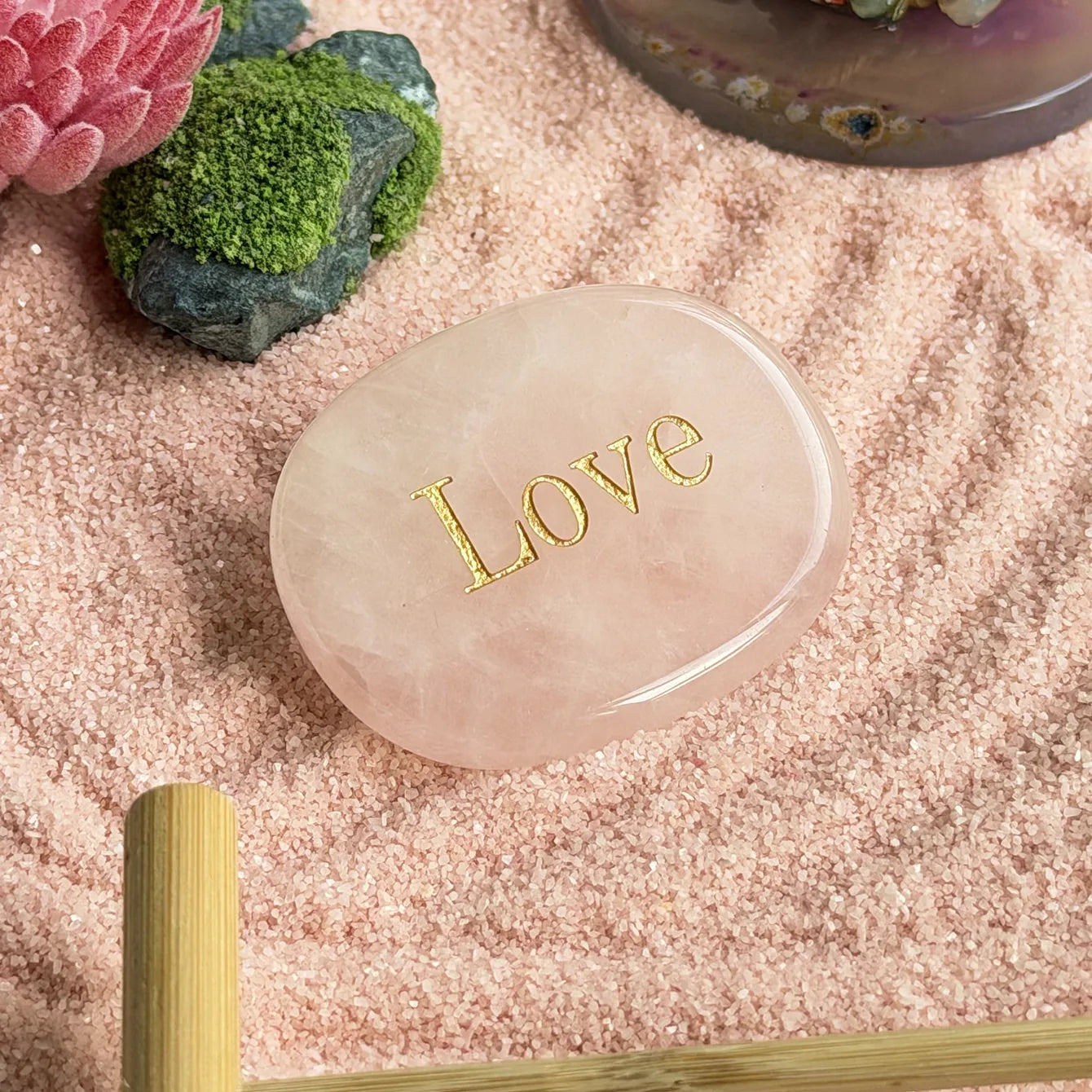 Pink lotus-inspired accent and moss-textured stones