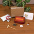 12-Zodiac Crystal Zen Garden personalized meditation kit with calming items, including a box, floral decor, and zodiac card.