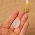 Portable meditation candle set with a hand holding a crystal and a burning beeswax candle in the background.