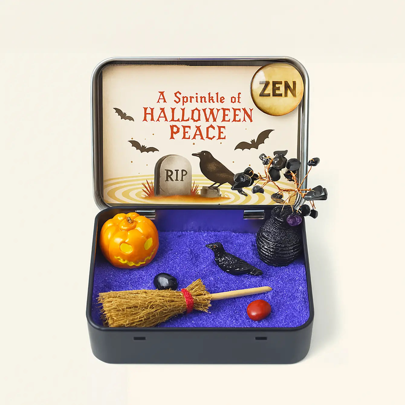 A decorative Zen box for Halloween featuring crystals, a pumpkin, and a broom, promoting peace with a Halloween theme.