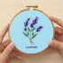 5-Hour Mindfulness Embroidery Kit featuring lavender design in a hoop, hands holding the finished embroidery.