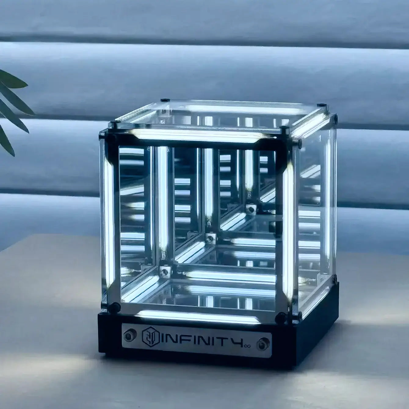 Clear cube with 'INFINITY' branding on a light background