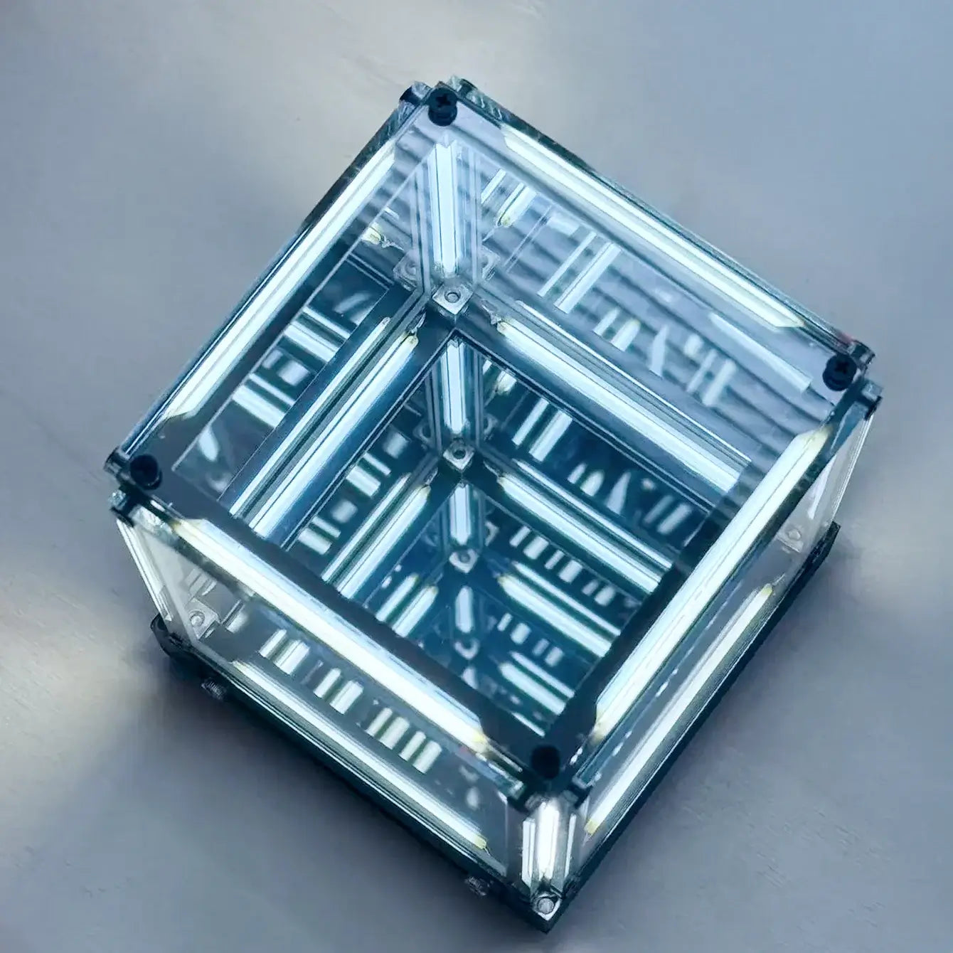 Clear cube with reflective interior on a gray background