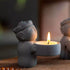 Zen-Stone Jizo Monk Cement Figurine holding a candle holder with a lit candle.