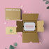 Love Endures Crystal Zen Garden displayed in an open box with pink petals on a soft pink background.