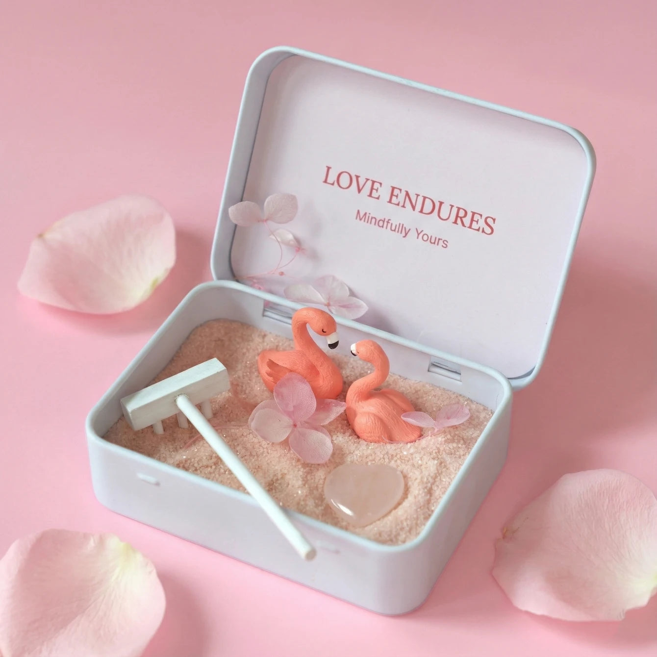 Love Endures Crystal Zen Garden with pink sand, rose quartz, and flamingo figurines in a decorative box.