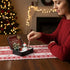 Woman relaxing with Christmas Crystal Zen Garden on a festive table, surrounded by holiday decorations.