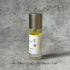 Portable Chakra Aromatherapy Mist for Yoga & Deep Meditation - 10ml bottle on a textured background.