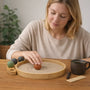 Woman enjoying a Desktop Zen Garden while interacting with textures and elements, creating a calm environment.