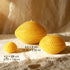 Three beeswax candles in geometric shapes, showcasing a warm yellow color and natural honey aroma.
