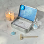Pisces Crystal Zen Garden featuring white sand, Aquamarine Tree, and blue aventurine star crystal in a decorative tin.