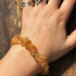 Natural Citrine Bracelet Jewelry worn on a hand, showcasing raw citrine crystals for energy and confidence.