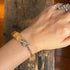 Natural Citrine Bracelet Jewelry displayed on a wrist, showcasing raw citrine crystals and a silver clasp.