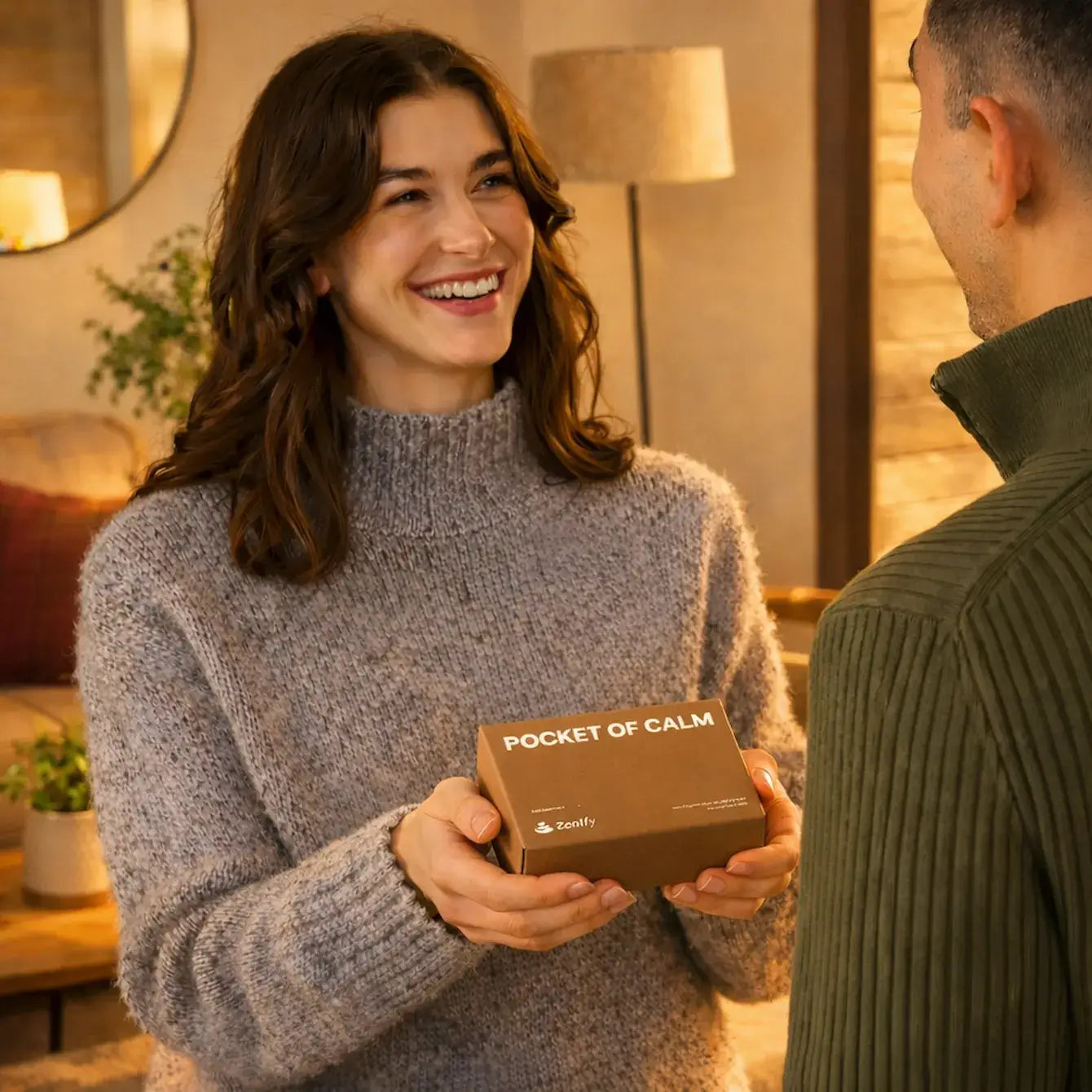 Smiling woman presenting the Pocket of Calm gift box to a man, showcasing relaxation and mindfulness.