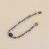 Lapis Lazuli Multi-Gemstone Woven Bracelet featuring colorful beads and an engraved Evil Eye centerpiece.