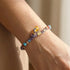 Lapis Lazuli Multi-Gemstone Woven Bracelet worn on model's wrist showcasing vibrant colors and intricate design.