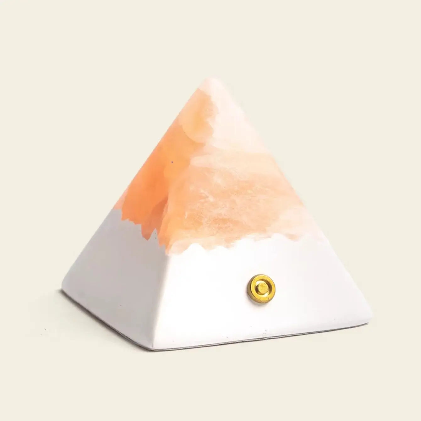 Mineral Pyramid Stone Lamp featuring a smooth surface and warm glow, ideal for meditation spaces and bedside tables.
