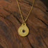 Circle of Harmony Necklace with dual-sided Bagua talisman and a purple gemstone on a gold chain.
