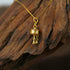 Zenify™ mantra wheel necklace featuring a gold prayer wheel pendant on a delicate chain.
