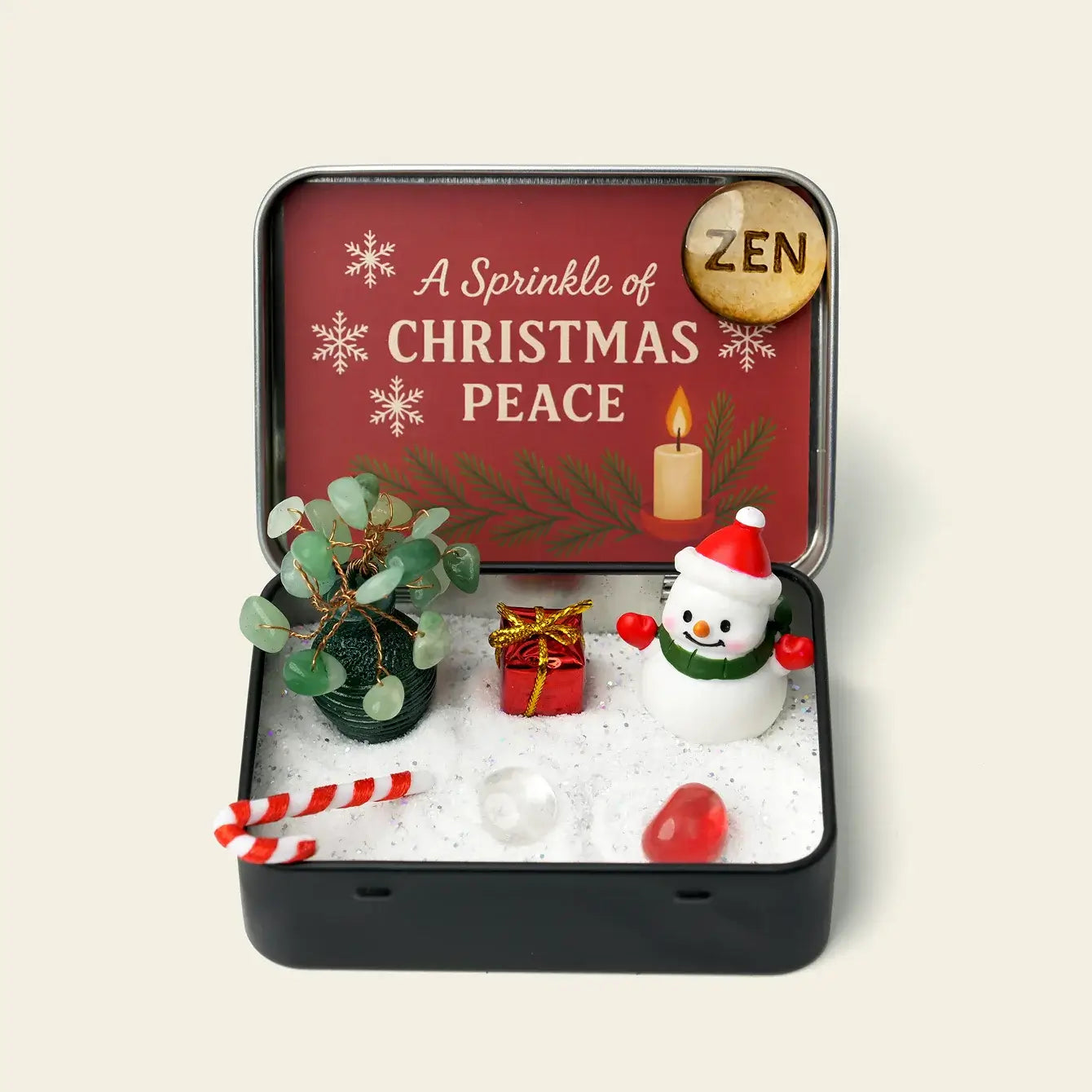 Zenify™ Christmas Zen Pocket Garden — a festive mini Zen set with a green aventurine tree, snowman, gift box, candy cane, and healing crystals on white sand.