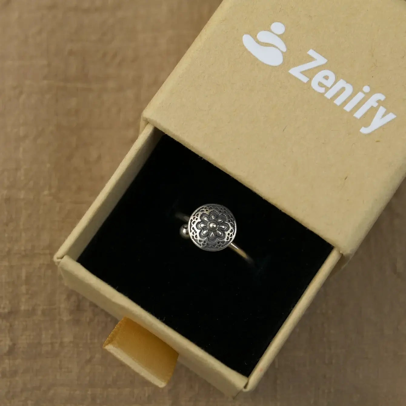Zenify™ Silver Mantra Ring presented in a stylish box, showcasing its intricate design and peaceful essence.