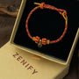 Zenify™ Sutra Light Knot – Handwoven blessing bracelet in a gift box featuring red and gold design.