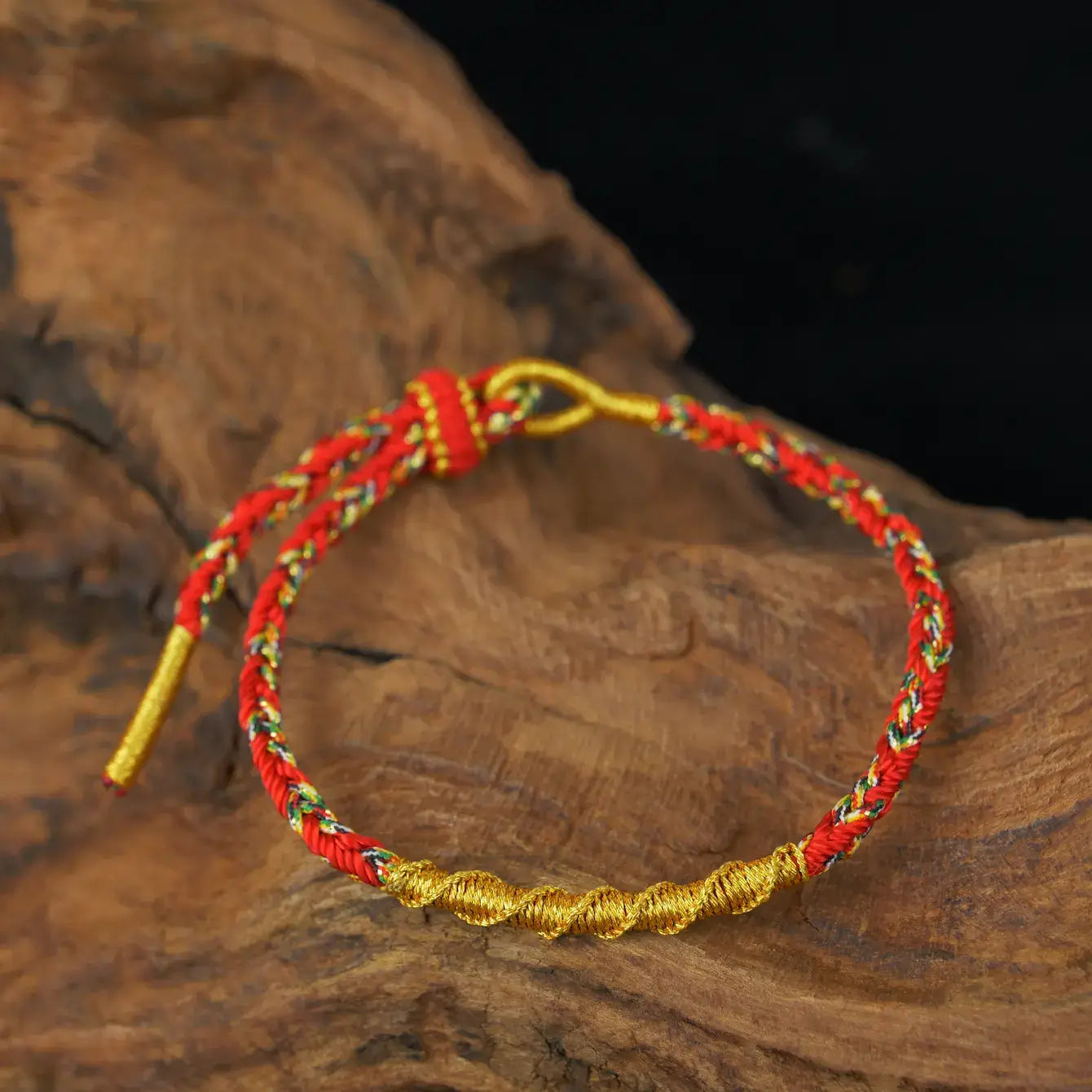 Zenify™ Fortune Knot – Handwoven Lucky Cord Bracelet in red and gold on a wooden background.