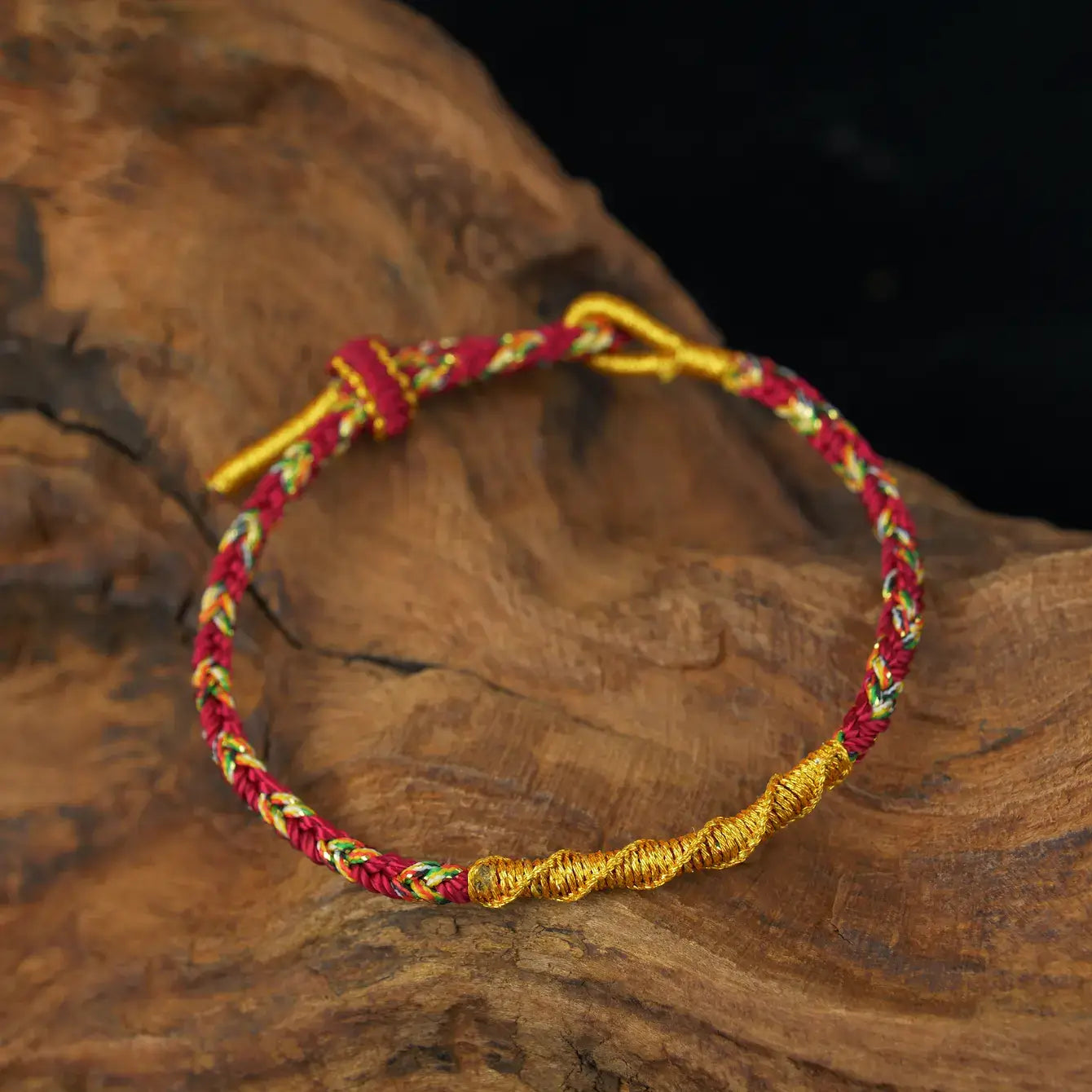 Zenify™ Fortune Knot – Handwoven Lucky Cord Bracelet in red and gold on wooden surface.