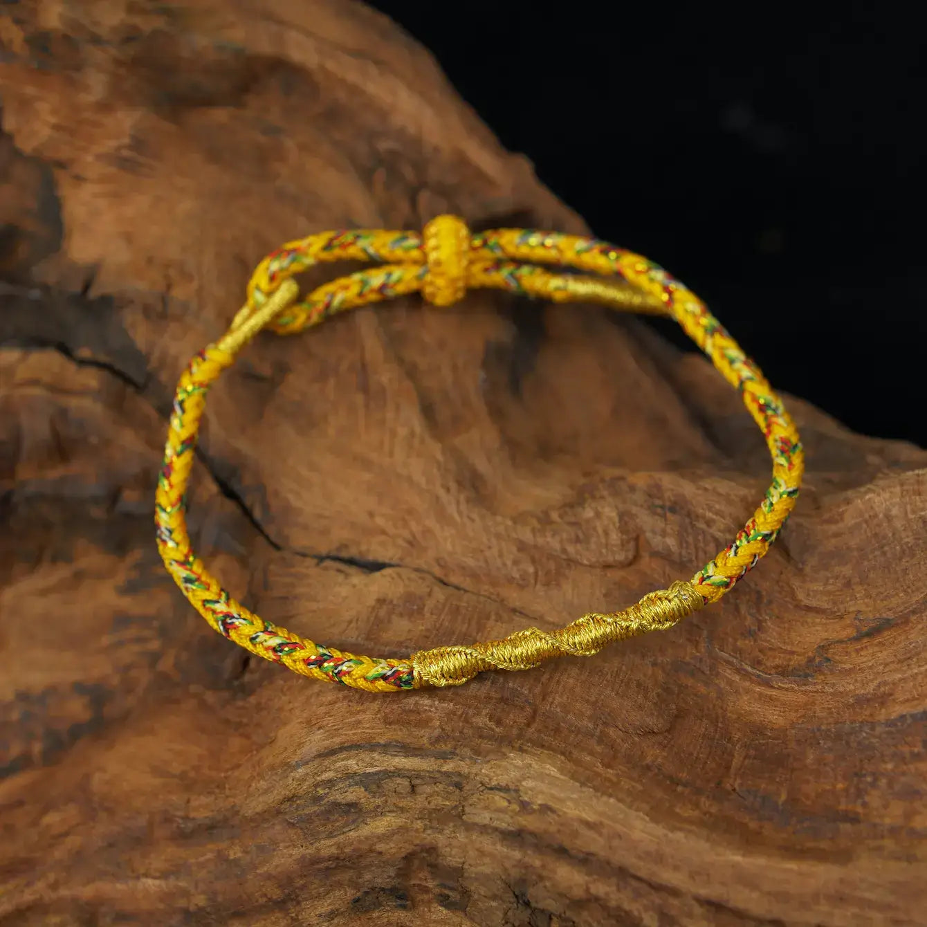 Zenify™ Fortune Knot – Handwoven Lucky Cord Bracelet in vibrant yellow against a wooden background.