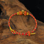 Zenify™ Sutra Light Knot – Handwoven blessing bracelet with red and gold design, symbolizing calm and protection.